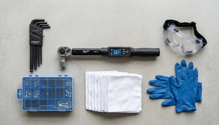 Essential tools and safety gear required for excavator hydraulic solenoid valve replacement, including a digital torque wrench, hex keys, safety goggles, and nitrile gloves.